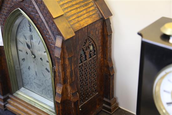 Carrew & Rule, Fenchurch Street, London. A Victorian Gothic design oak hour repeating bracket clock, clock 21in., bracket 15.5in.
